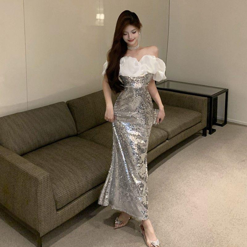 فستان سهرة فاخر بتصميم فرنسي أنيق بأكتاف مكشوفة، مزين بالترتر اللامع وقصة حورية البحر الراقية، مثالي للمناسبات الفخمة كحفلات الخطوبة أو المناسبات الرسمية