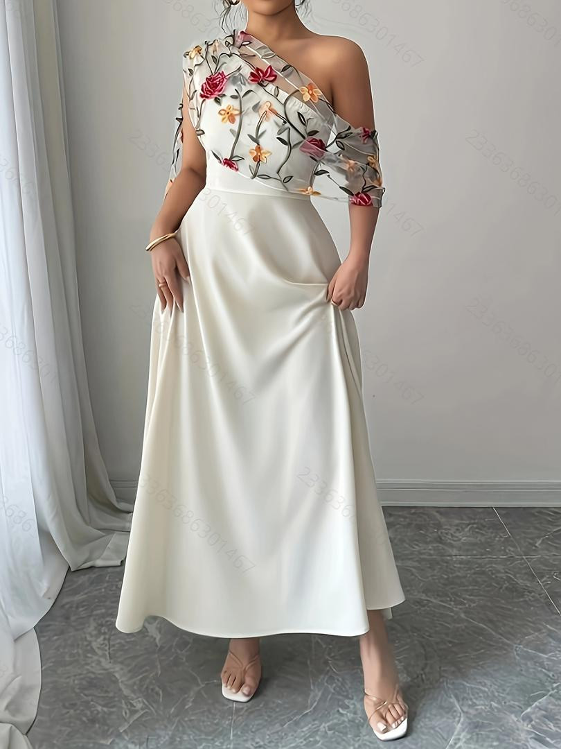 فستان أنيق بكتف مائل بتطريز زهور ناعمة من التول وبقصة خصر تحدد القوام بلمسة راقية